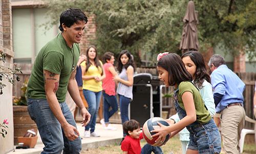 young man and two girls playing basketball