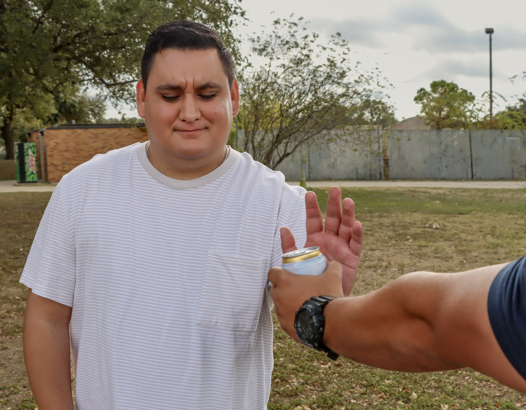 man refusing can of beer