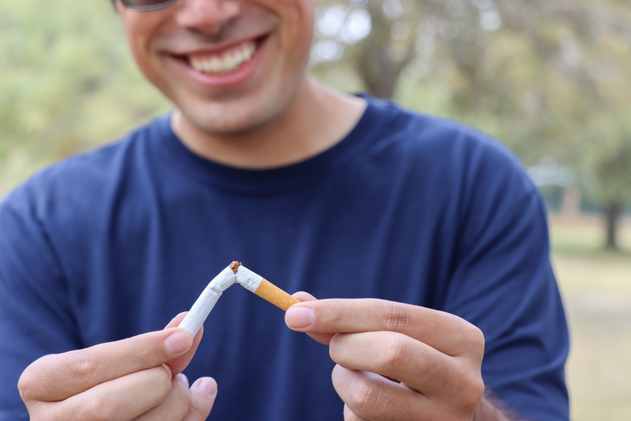 man breaking cigarette