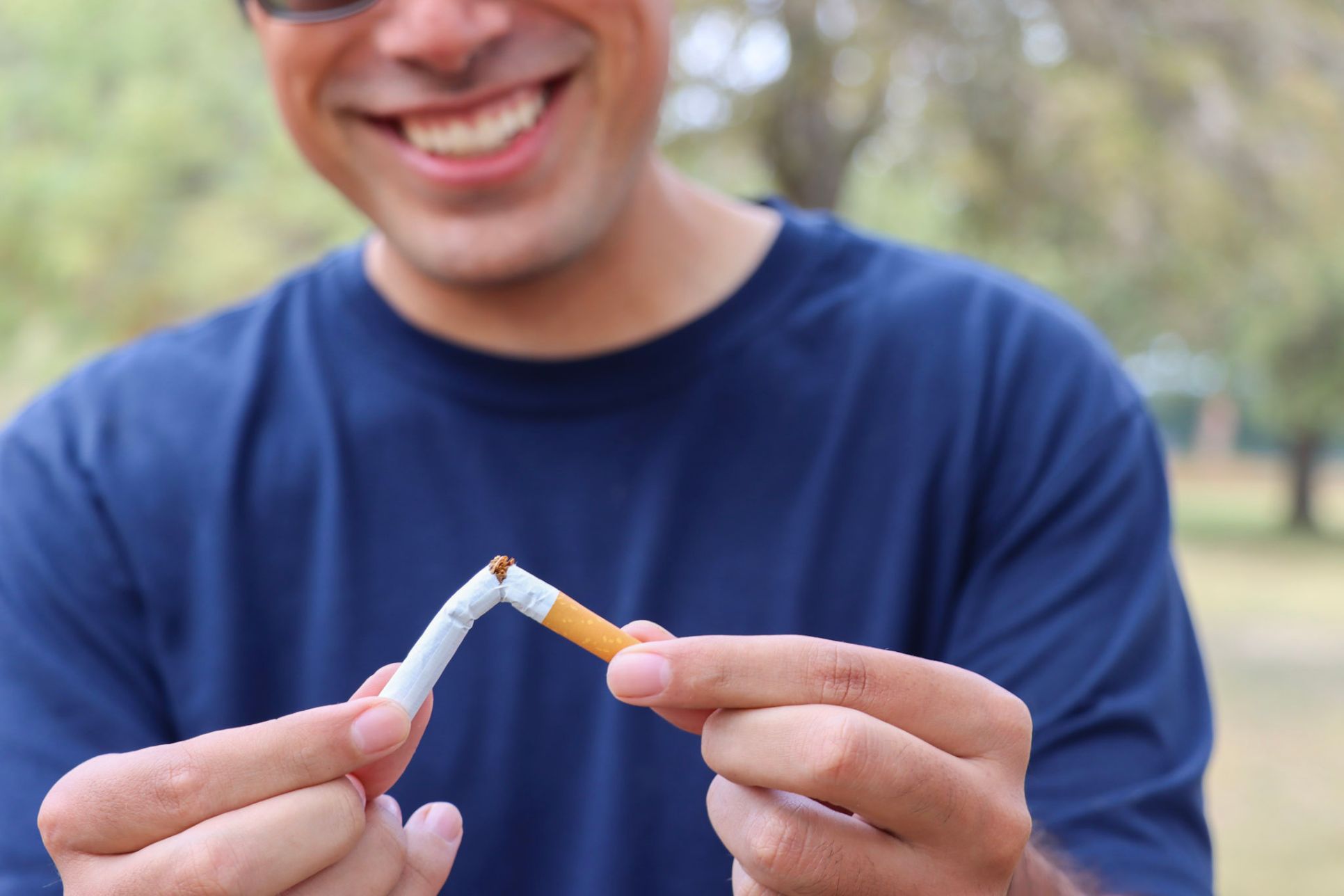 man breaking cigarette
